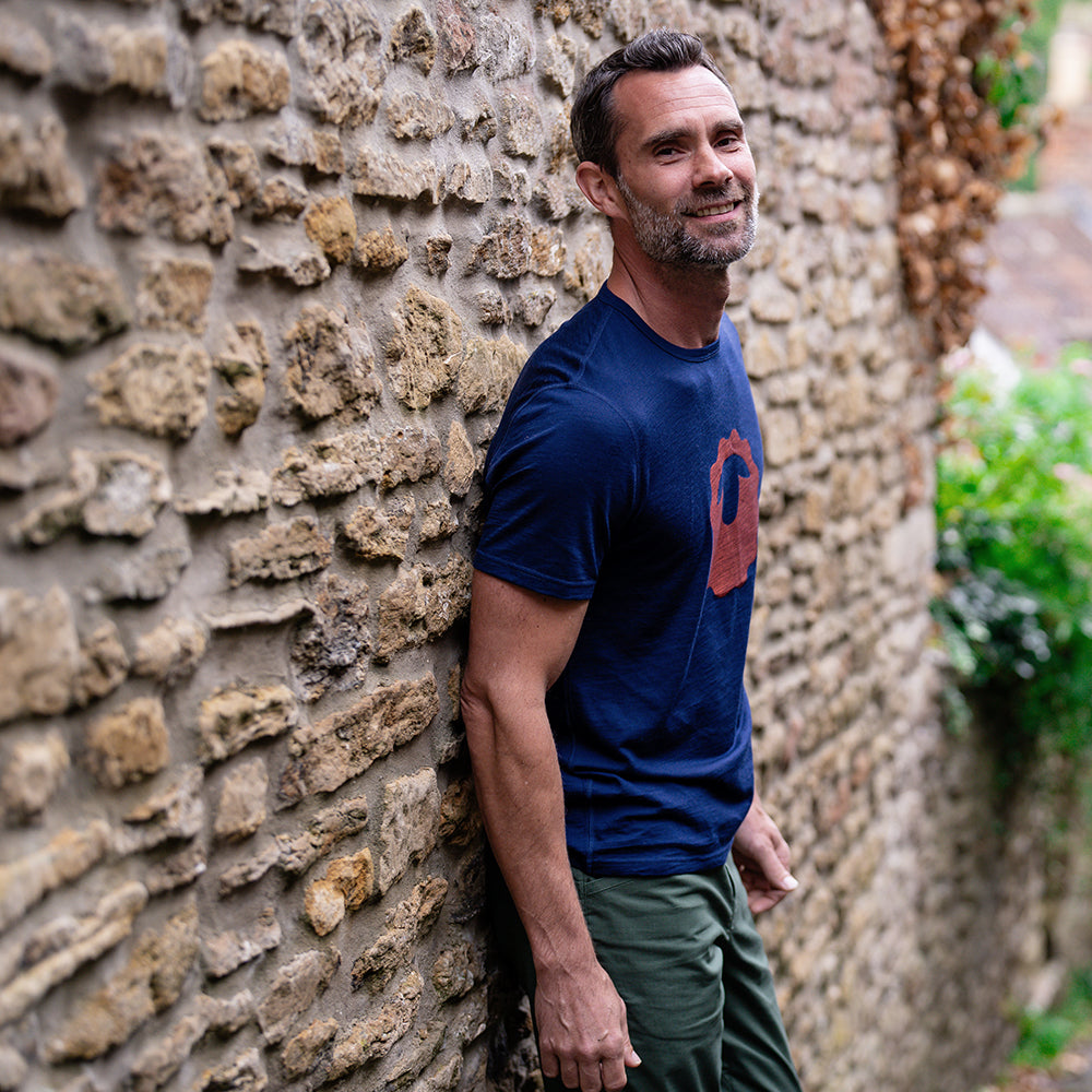 Isobaa | Mens Merino 150 Emblem Tee (Navy/Orange) | Conquer trails and city streets in comfort with Isobaa's superfine Merino T-Shirt. | Model: Ben
