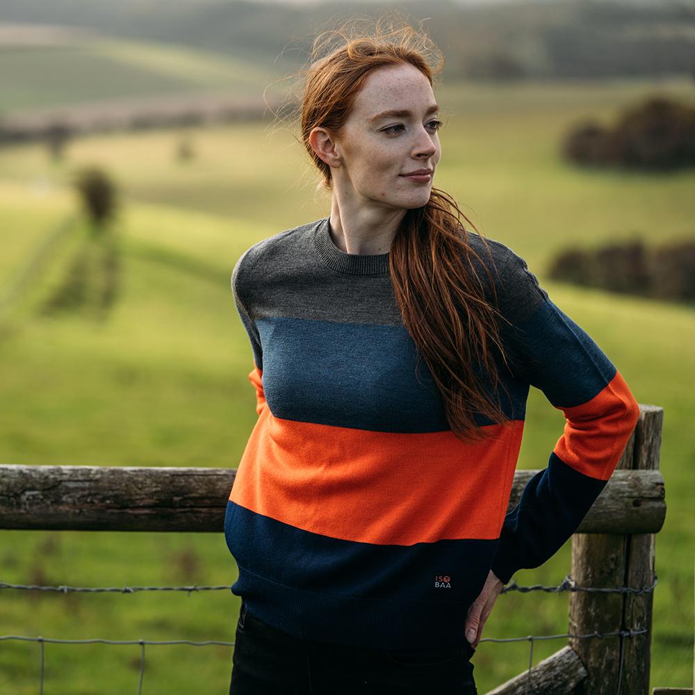 Isobaa | Womens Merino Block Stripe Sweater (Smoke/Denim/Orange/Navy) | Discover effortless style and exceptional comfort with our extrafine 9-gauge Merino wool crew neck sweater. | Model: Sophie