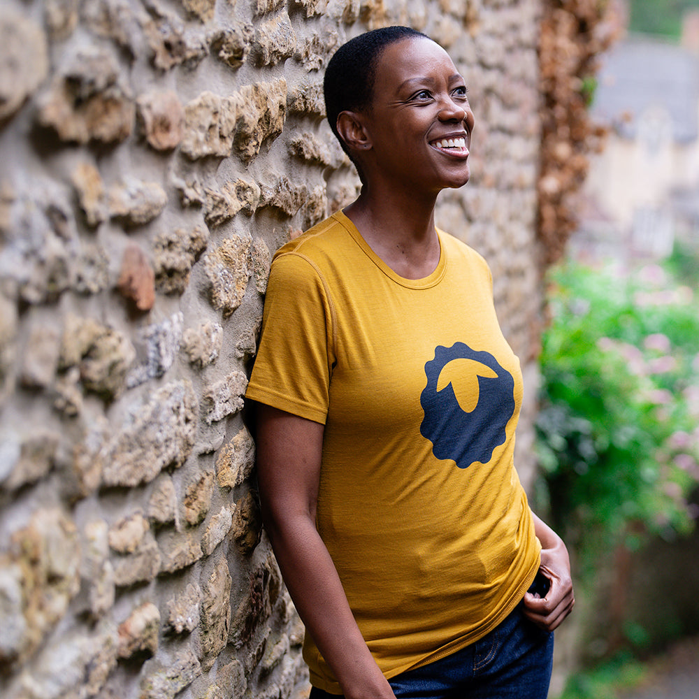 Isobaa | Womens Merino 150 Emblem Tee (Mustard/Navy) | Conquer trails and city streets in comfort with Isobaa's superfine Merino T-Shirt. | Model: Yolisa