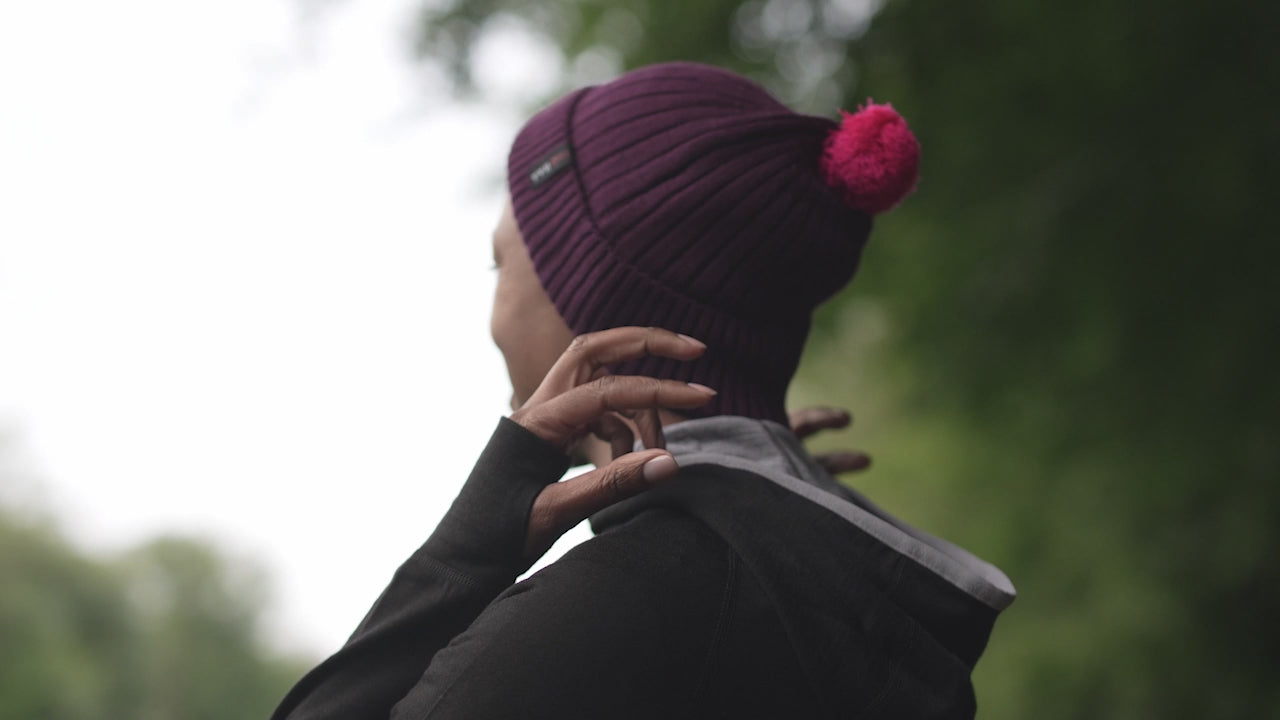 Isobaa | Merino Bobble Beanie (Wine/Fuchsia) | Stay warm and stylish with Isobaa's extra-fine Merino bobble beanie! Its cosy warmth, playful bobble, and classic rib-knit design will make it your go-to winter essential for hikes, city strolls, and everything in between. | align: 55% 50%