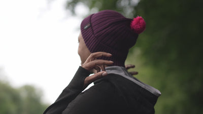 Isobaa | Merino Bobble Beanie (Wine/Fuchsia) | Stay warm and stylish with Isobaa's extra-fine Merino bobble beanie! Its cosy warmth, playful bobble, and classic rib-knit design will make it your go-to winter essential for hikes, city strolls, and everything in between. | align: 55% 50%